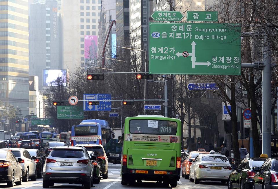 In this Wednesday, Dec. 28 photo, a dual-language traffic sign written in Korean and English is displayed over the road in Seoul, South Korea. Impeached President Park Geun-hye's surname is "Park," right? Nope. In Korean it's closer to "Bahk." Park's allegedly corrupt confidante, Choi Soon-sil, pronounces her name more like "Chwey" than the way it's rendered in English. There is a gulf, often a wide one, between the way Koreans write their names in English and the way they actually sound. (AP Photo/Ahn Young-joon)