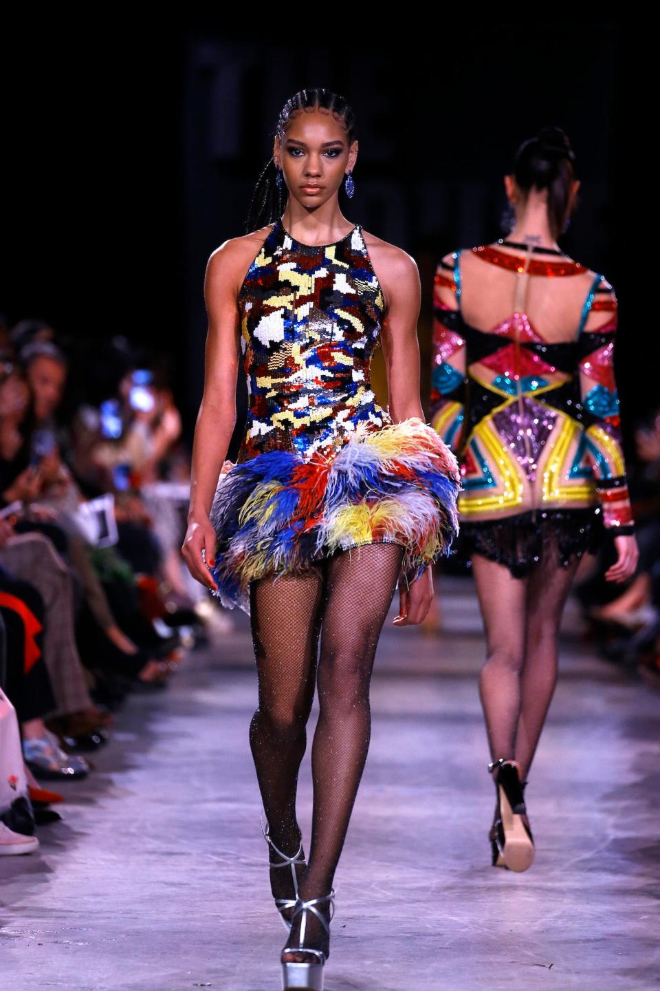 A model wears a Mondrian-inspired minidress with feathers during the Naeem Khan runway show at New York Fashion Week.