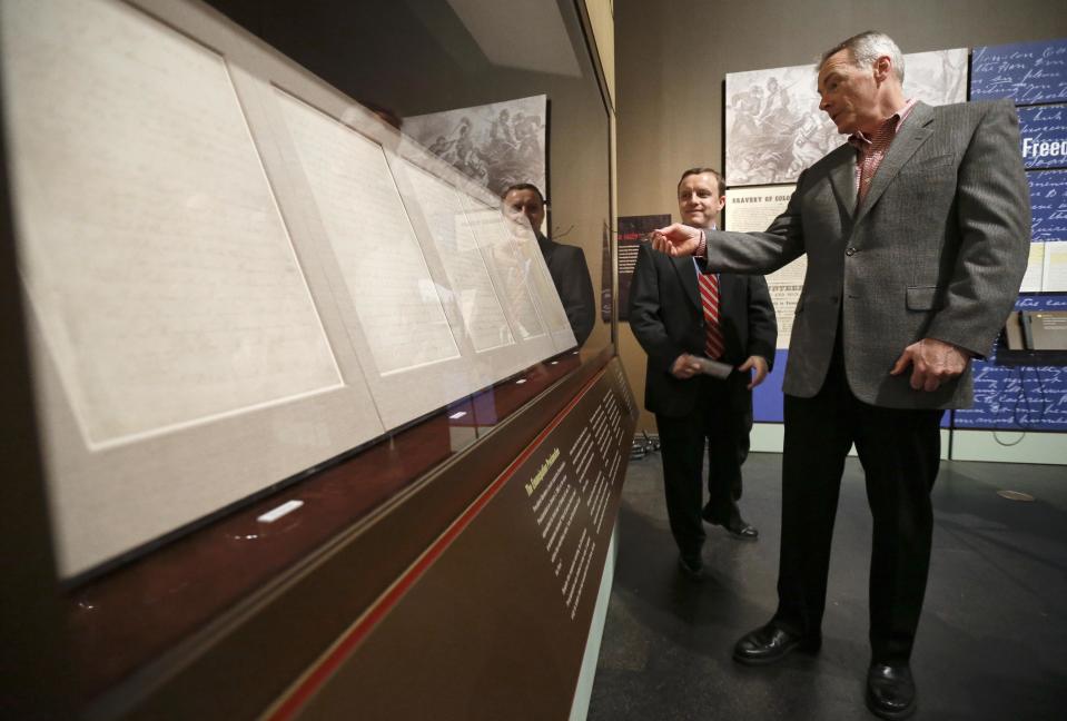 Wayne Moore, right, looks over the Emancipation Proclamation with the help of Jeff Sellers, left, the curator of education at the Tennessee State Museum on Monday, Feb. 11, 2013, in Nashville, Tenn. The document is at the museum in conjunction with an exhibit titled Discovering the Civil War from the National Archives. The papers will only be on view for 72 hours, which is being spread over seven days. It is scheduled to go on view to the public Tuesday, Feb. 12, and close Monday, Feb. 18. (AP Photo/Mark Humphrey)