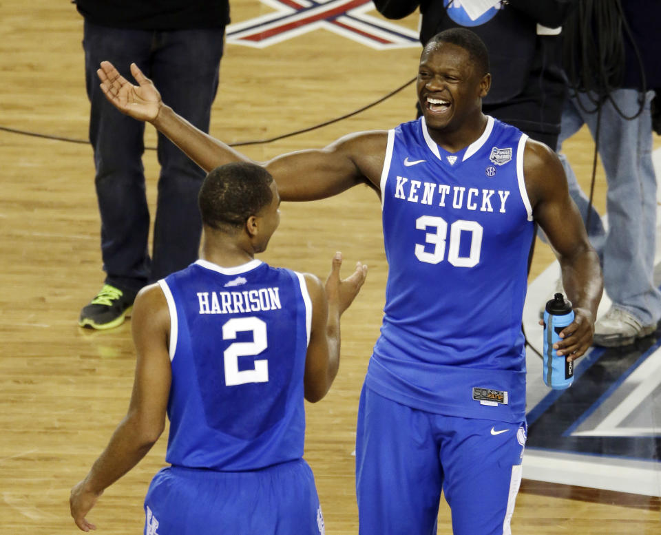 After Kentucky guard Aaron Harrison (2) made a three-point basket in the final seconds against Wisconsin to win the game 74-73, he celebrates with Julius Randle (30) at the end of their NCAA Final Four tournament college basketball semifinal game Saturday, April 5, 2014, in Arlington, Texas. (AP Photo/Tony Gutierrez)