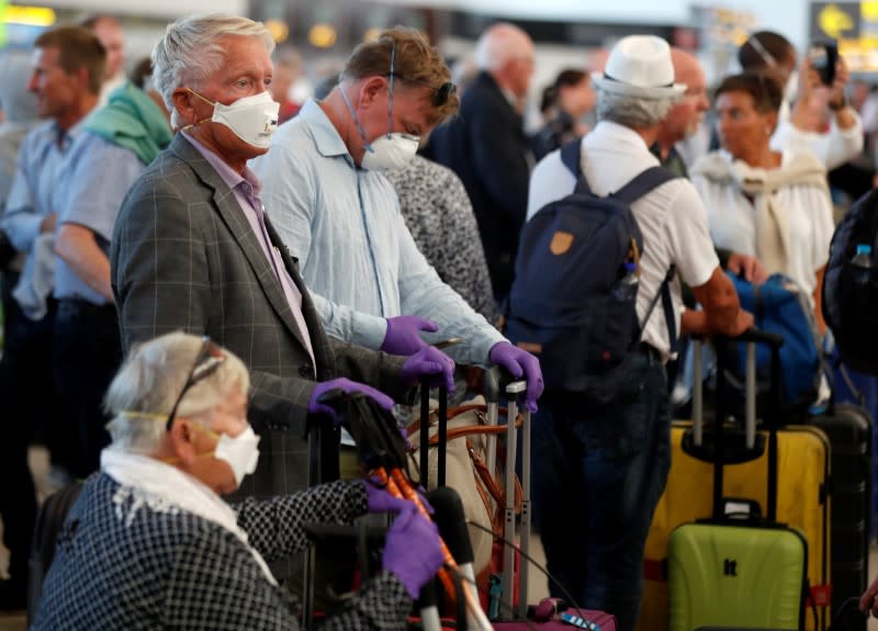 Tourists at Gran Canaria airport wait to return to their countries after closure of hotels