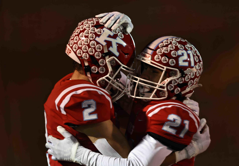 Kings wide receiver Michael Mussari (2) celebrates with Elijah Jones (21) after scoring a touchdown during their division II regional final against Anderson Friday, Nov. 18.