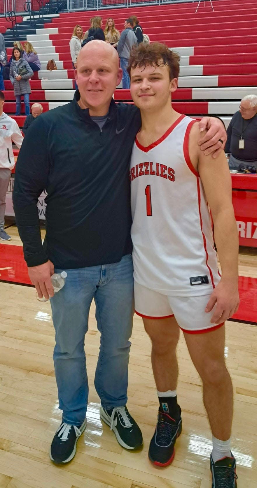 Jami Bosley (left) and his son, Maxx, pose for a picture after Maxx's 47-point game for Wadsworth last year against the North Royalton boys basketball team.