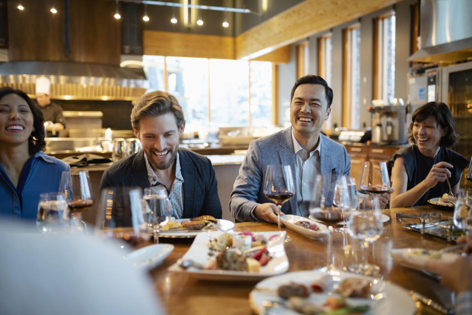 Happy business people dining at restaurant table