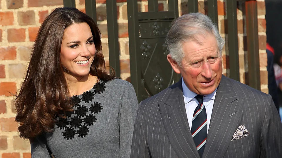 Kate Middleton and King Charles wearing matching grey outfits and smiling while out in public