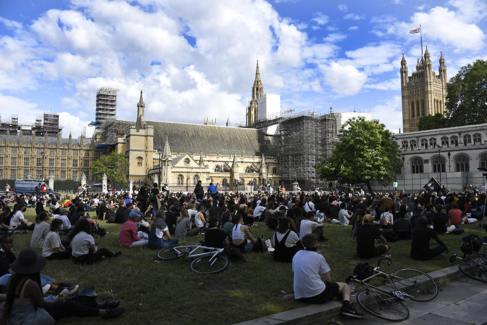 People gather for a protest, organised by Black Lives Matter, at the Parliament Square in central London, Sunday, June 21, 2020, in the wake of the killing of George Floyd by police officers in Minneapolis, USA last month that has led to anti-racism protests in many countries calling for an end to racial injustice. Anti-racism demonstrators are holding a fourth weekend of protests across the U.K.(AP Photo/Alberto Pezzali)