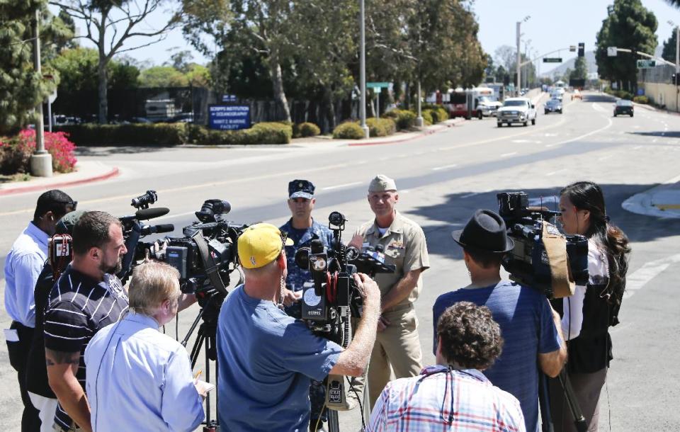 Captain Scott F. Adams, right, Commanding Officer Navy Base Point Loma, accompanied by Lt. Commander Steve Ruh, talks about an incident on the base in which a sailor was arrested for operating an Airsoft weapon on the base, Thursday, April 24, 2014, in San Diego. A second sailor who was a friend of the sailor with the weapon was also arrested. (AP Photo/Lenny Ignelzi)