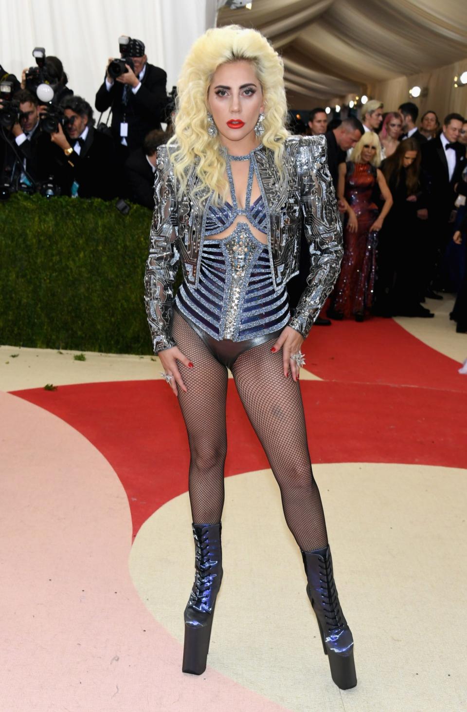 <p>Lady Gaga walked out as her old self at the Met Ball in a metallic Versace number and super high platforms. <i>[Photo: Getty]</i> </p>