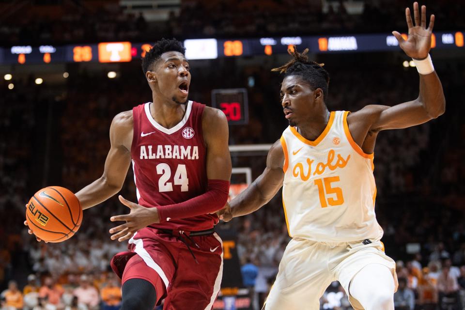 Alabama forward Brandon Miller (24) is defended by Tennessee guard Jahmai Mashack (15) during a basketball game between the Tennessee Volunteers and the Alabama Crimson Tide held at Thompson-Boling Arena in Knoxville, Tenn., on Wednesday, Feb. 15, 2023. 