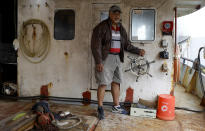 In this Tuesday, April 9, 2019, photo, fisherman and former politician Teisina Fuko on his fishing boat in Nuku'alofa, Tonga. China is pouring billions of dollars in aid and low-interest loans into the South Pacific, and even in the far-flung kingdom of Tonga there are signs that a battle for power and influence among much larger nations is heating up and could exact a toll. (AP Photo/Mark Baker)