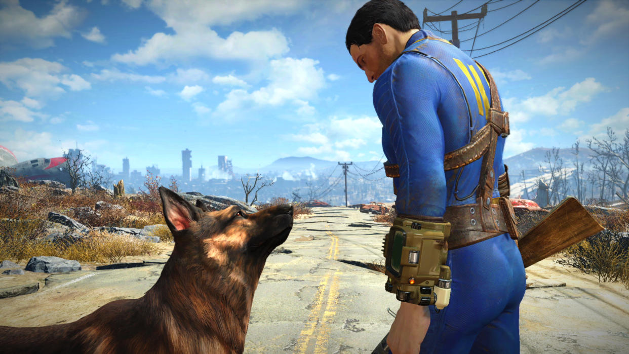  Fallout 4 character wearing the signature blue and yellow Vault Dweller outfit while standing beside Dogmeat, a German Shepherd dog. 