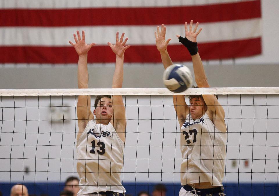 Webster’s Brody Groff (13) and Calvin Lill go up for a block against Fairport. 