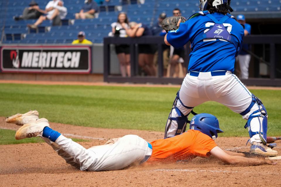 Olentangy Orange's Cole Cahill scores the winning run on Keegan Knupp's suicide squeeze bunt in the bottom of the ninth.