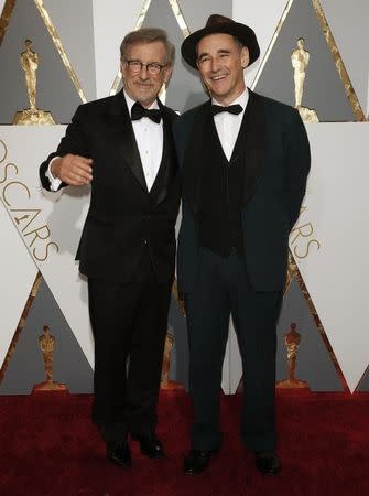 Mark Rylance, nominated for Best Supporting Actor for his role in "Bridge of Spies", arrives with director Steven Spielberg (R) at the 88th Academy Awards in Hollywood, California February 28, 2016. REUTERS/Adrees Latif