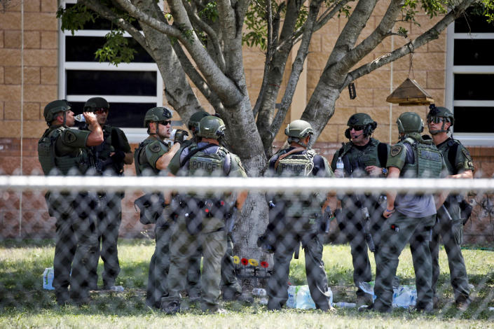 Law enforcement personnel stand outside Robb Elementary School following a shooting on May 24, 2022, in Uvalde, Texas. (Dario Lopez-Mills / AP)