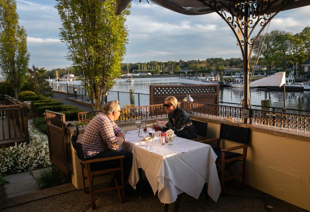 Patrons, including Laura McKittrick, C, enjoy drinks at L'escale restaurant on May 20, 2020 in Greenwich, Connecticut.