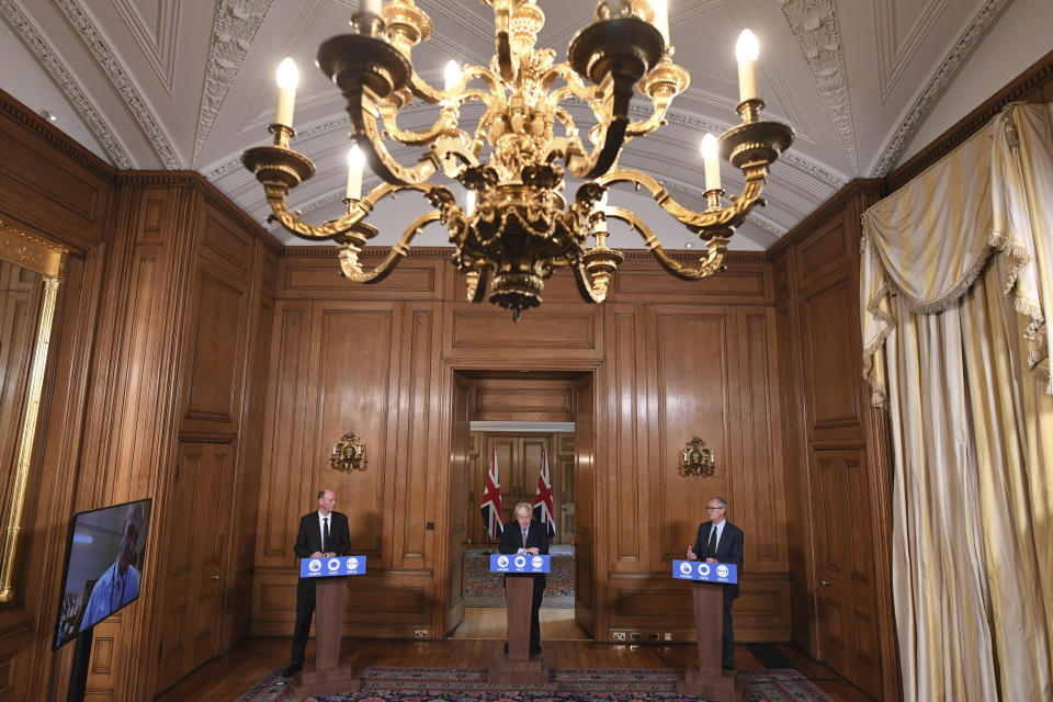 A government virtual press conference, with from left to right, Chief Medical Officer Professor Chris Witty, Prime Minister Boris Johnson and Chief Scientific Adviser Sir Patrick Vallance, at Downing Street in London, Wednesday Sept. 9, 2020, following the announcement that the legal limit on social gatherings is set to be reduced from 30 people to six. The change in England will come into force on upcoming Monday as the Government seeks to curb a recent ongoing rise in coronavirus cases. (Stefan Rousseau/Pool via AP)