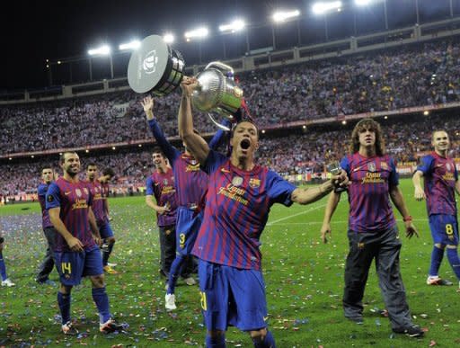 Barcelona's Adriano Correia lifts the Cup as he celebrates his team's Spanish Cup victory on May 25. Barcelona defeated Athletic Bilbao 3-0