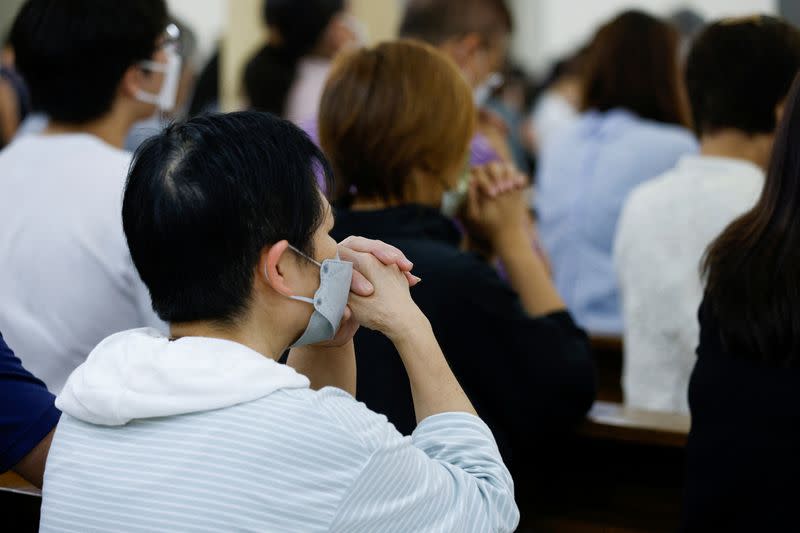 Catholic worshipers pray at a church, in Hong Kong