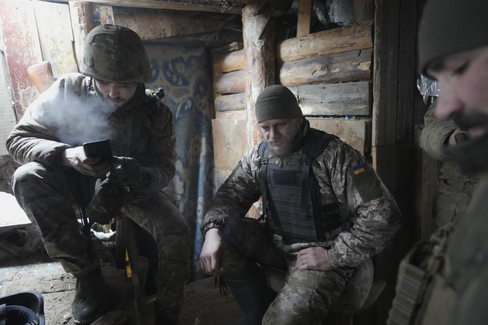Ukrainian servicemen take a rest in a shelter on the front line in the Luhansk region, eastern Ukraine, Friday, Jan. 28, 2022. High-stakes diplomacy continued on Friday in a bid to avert a war in Eastern Europe. The urgent efforts come as 100,000 Russian troops are massed near Ukraine's border and the Biden administration worries that Russian President Vladimir Putin will mount some sort of invasion within weeks. (AP Photo/Vadim Ghirda)