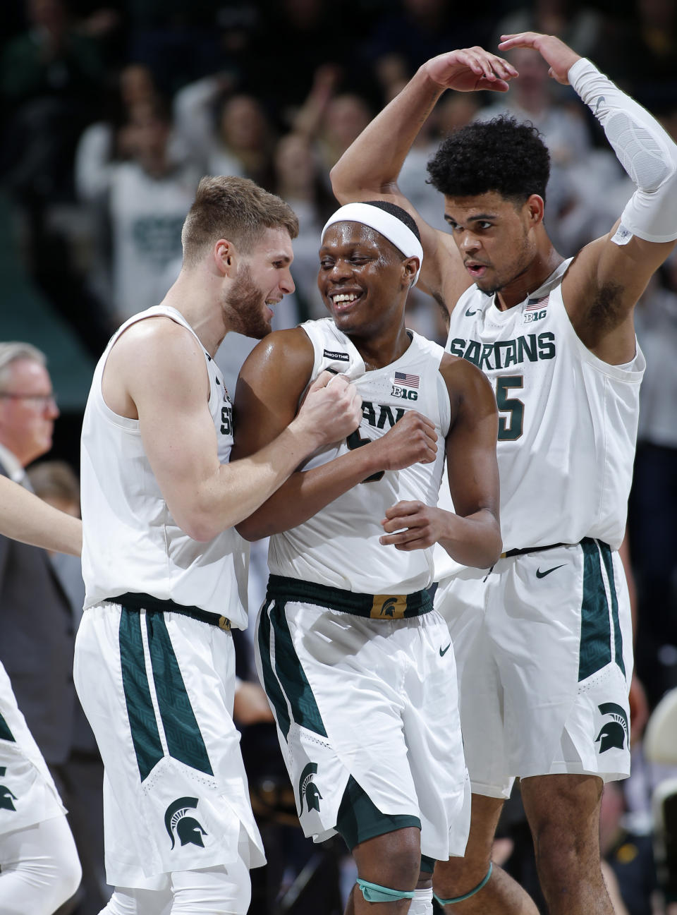 Michigan State's Kyle Ahrens, left, Cassius Winston, center, and Malik Hall celebrate during the second half of an NCAA college basketball game against Iowa, Tuesday, Feb. 25, 2020, in East Lansing, Mich. Michigan State won 78-70. (AP Photo/Al Goldis)