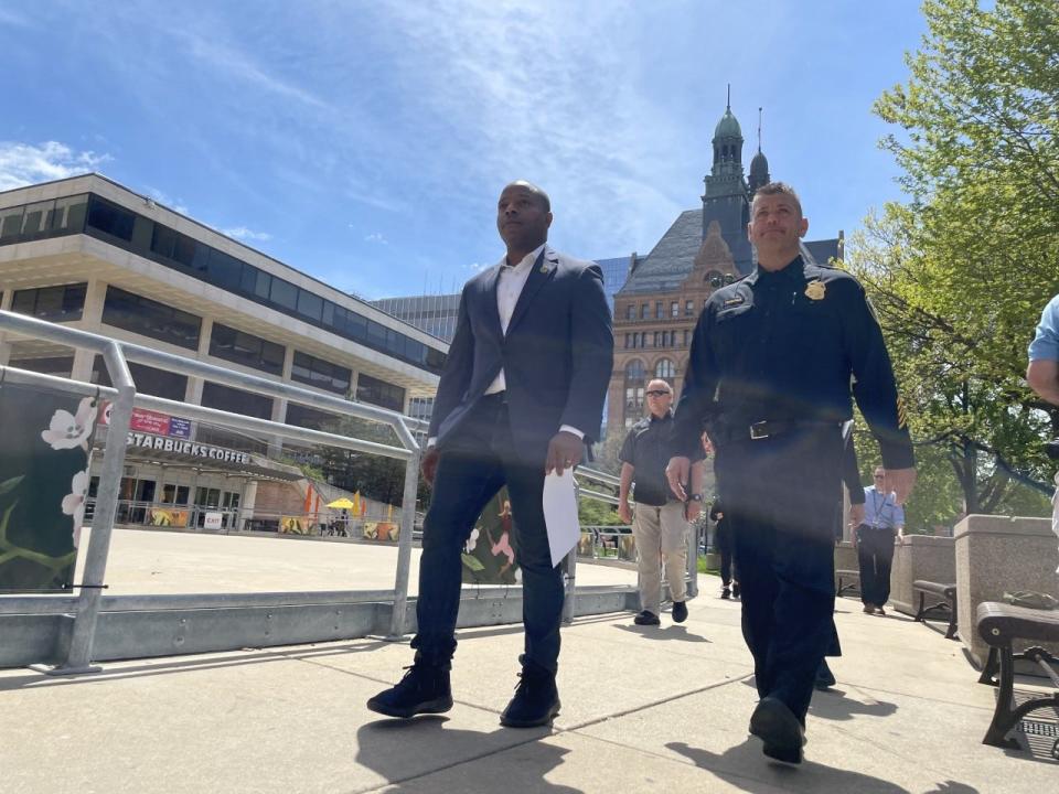 Mayor Cavalier Johnson (left) and Milwaukee Assistant Police Chief Paul Formolo prepare to address members of the media at a press conference Saturday, May 14, 2022. At least 21 people were injured in shootings in downtown Milwaukee following the Bucks game on May 13.