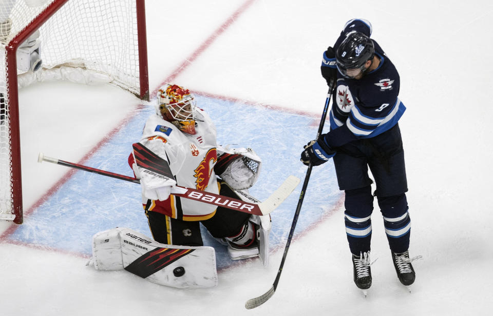 Calgary Flames goalie Cam Talbot (39) makes a save on Winnipeg Jets' Andrew Copp during the third period of an NHL qualifying round game, in Edmonton, Alberta, Thursday, Aug. 6, 2020. (Jason Franson=/The Canadian Press via AP)