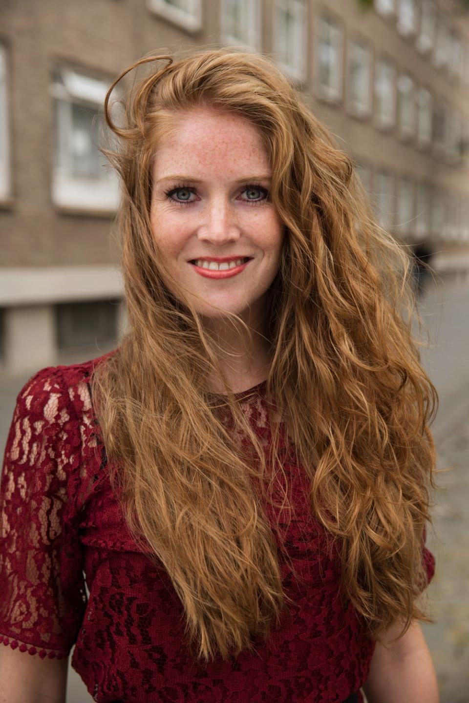 A redhead named Judith from Breda, Netherlands, poses outside