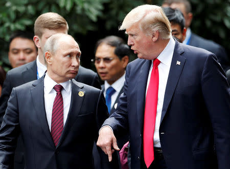 FILE PHOTO: U.S. President Donald Trump and Russia's President Vladimir Putin talk during the family photo session at the APEC Summit in Danang, Vietnam November 11, 2017. REUTERS/Jorge Silva/File Photo