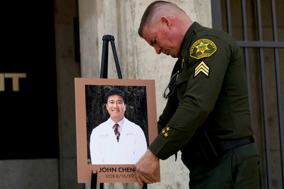 Orange County Sheriff's Sgt. Scott Steinle displays a photo of Dr. John Cheng, who was killed on May 15, 2022, at  the Geneva Presbyterian Church in Laguna Woods, Calif.