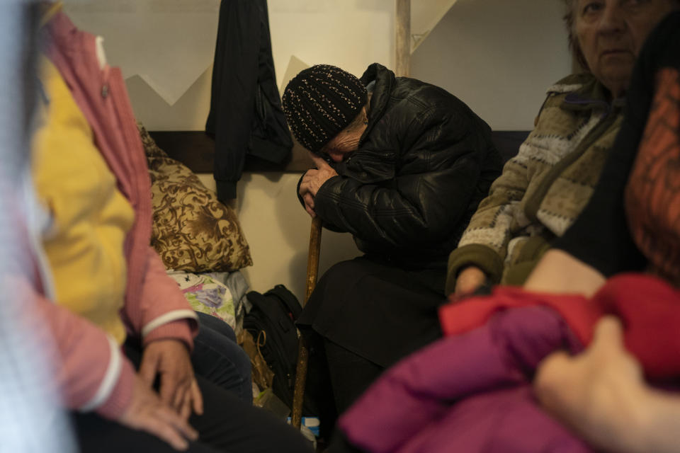 Catherina, 82, cries as she talks about the day she left her house carrying only the clothes the she is wearing to flee the Russian attacks in her town, as she sits on a bed settled in a restaurant that was transformed into a shelter for those who are fleeing the war from the eastern region of the country in Dnipro, Ukraine, Wednesday, April 20, 2022. The U.N. refugee agency says more than 5 million refugees have fled Ukraine since Russian troops invaded the country. The agency announced the milestone in Europe's biggest refugee crisis since World War II on Wednesday, April 20, 2022. (AP Photo/Leo Correa)