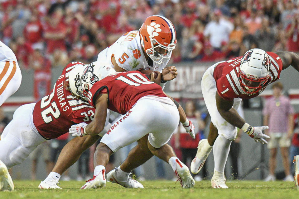 RALEIGH, NC - SEPTEMBER 25: Clemson Tigers quarterback D.J. Uiagalelei (5) is hit on a keeper during the game between the Clemson Tigers and the NC State Wolfpack on September 25, 2021 at Carter-Finley Stadium in Raleigh, NC. (Photo by William Howard/Icon Sportswire via Getty Images)