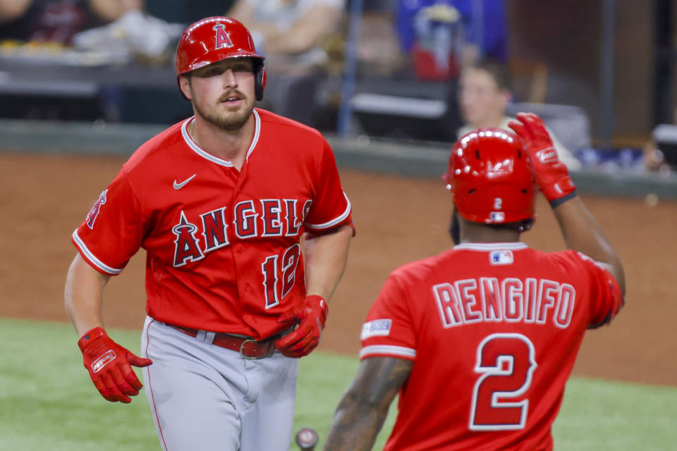 Los Angeles Angels' Hunter Renfroe (12) and Luis Rengifo (2) celebrate together after Renfroe hit a home run during the sixth inning of a baseball game against the Texas Rangers, Tuesday, June 13, 2023, in Arlington, Texas. (AP Photo/Gareth Patterson)