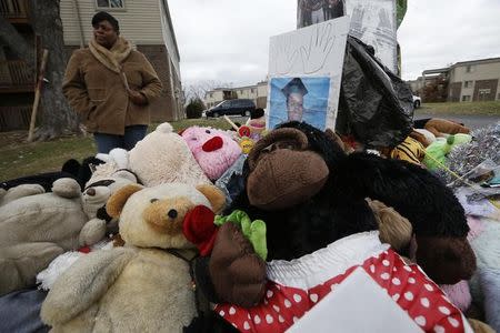 A woman looks at the memorial set up at the site of the shooting death of Michael Brown in Ferguson, Missouri, November 24, 2014. REUTERS/Jim Young