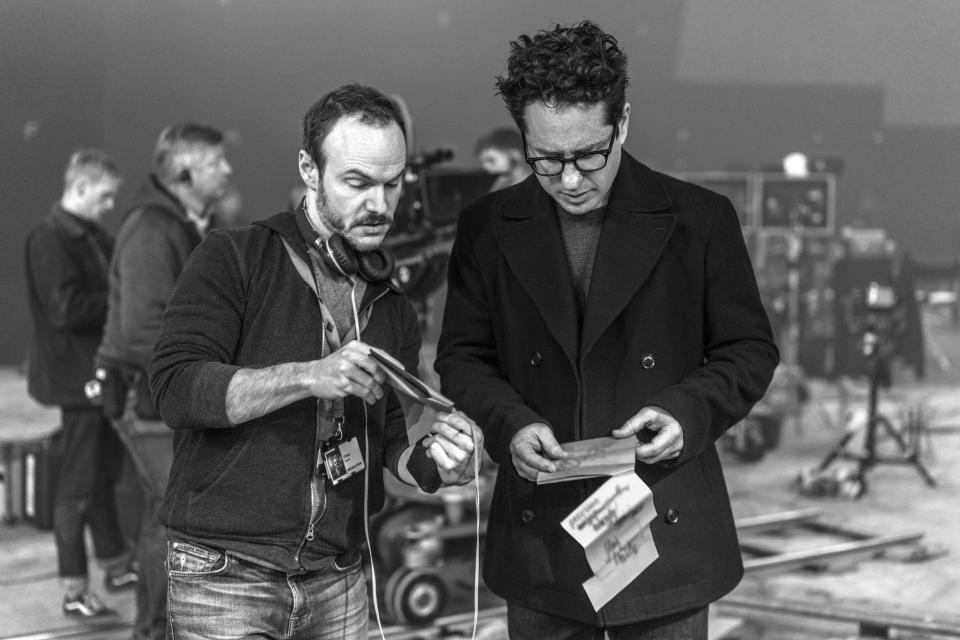 Lifelong "Star Wars" fans and co-writers Chris Terrio (left) and J.J. Abrams go over a scene on the set of "The Rise of Skywalker."