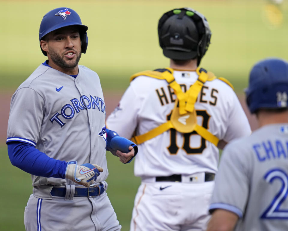 Toronto Blue Jays' George Springer, left, scores on a single by. Daulton Varsho off Pittsburgh Pirates starting pitcher Johan Oviedo during the first inning of a baseball game in Pittsburgh, Saturday, May 6, 2023. (AP Photo/Gene J. Puskar)