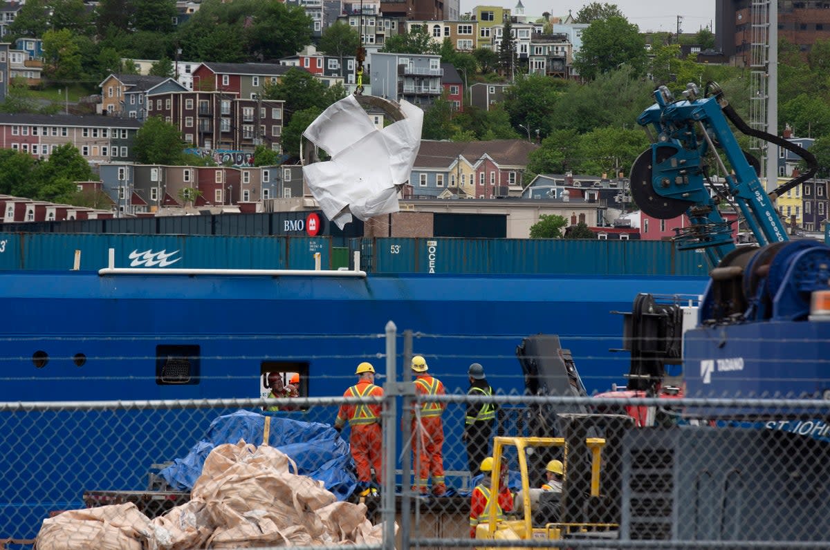 Debris from the Titan submersible, recovered from the ocean floor near the wreck of the Titanic, is unloaded from the ship Horizon Arctic at the Canadian Coast Guard pier in St. John's, Newfoundland (AP)