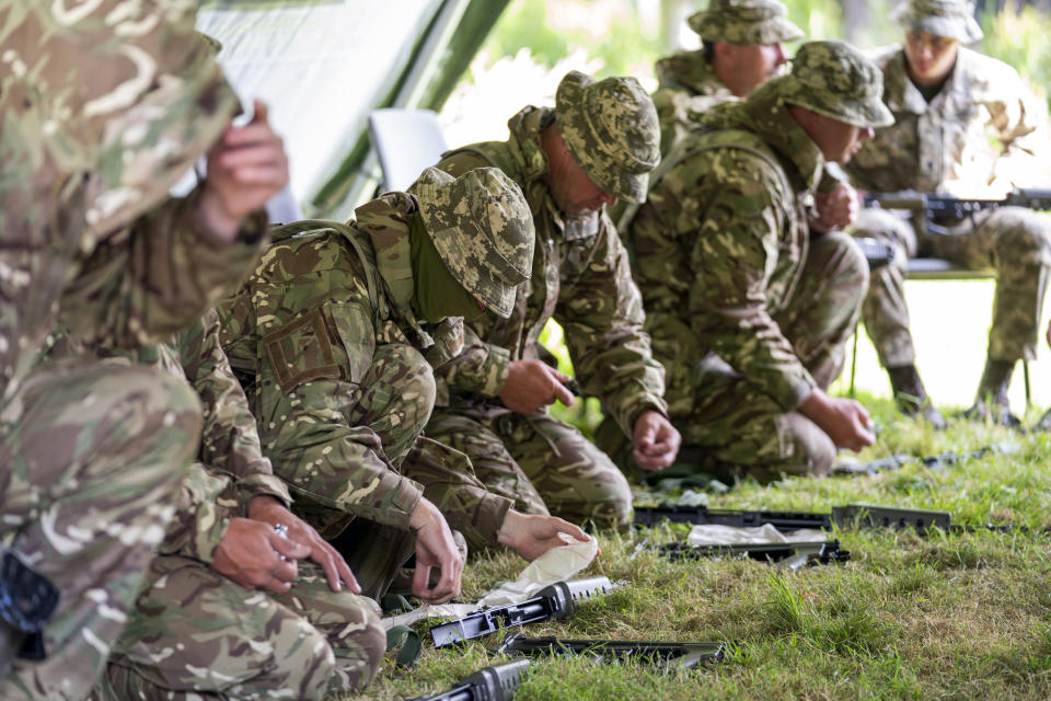 New recruits to the Ukrainian army are trained by UK army specialists at a military base near Manchester, England, Thursday, July 7, 2022. (Louis Wood/Pool Photo via AP)