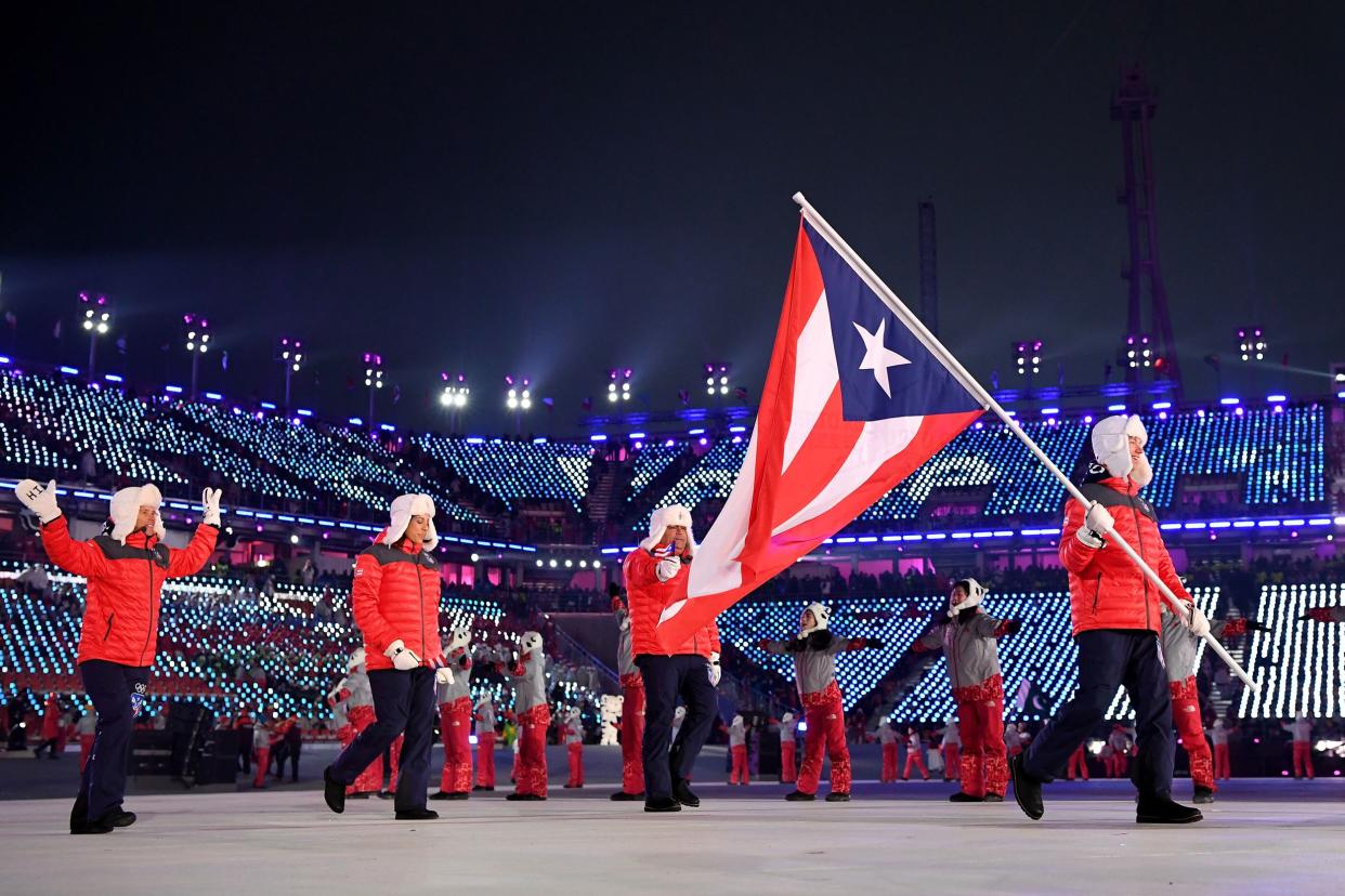 flag bearer charles flaherty of puerto rico and teammates arrive at the stadium during the opening ceremony of the pyeongchang 2018 winter olympic games at pyeongchang olympic stadium on february 9, 2018 in pyeongchang-gun, south korea