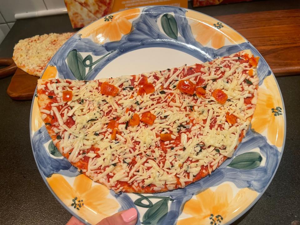 Pizza on a plate before being microwaved