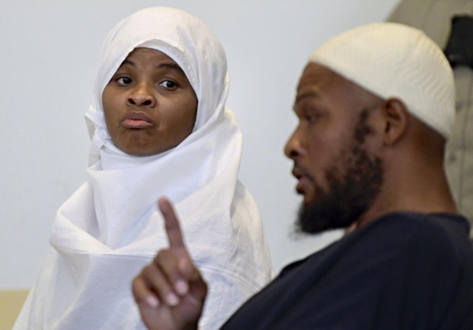 File - In this Aug. 13, 2018 file photo, defendants Hujrah Wahhaj, left, and Siraj Wahhaj talk during a break in court hearings in Taos, N.M. The Wahhajs were among several people arrested after authorities raided a property and found 11 children living on a squalid compound on the outskirts of tiny Amalia, N.M. The five men and women found living in a ramshackle compound in northern New Mexico where a boy was found dead last year have been indicted on federal charges related to terrorism, kidnapping and firearms violations. The U.S. attorney's office in New Mexico announced the superseding indictment Thursday, March 14, 2019. (Roberto E. Rosales/The Albuquerque Journal via AP, Pool, File)