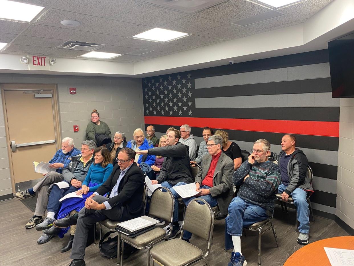 Ontario resident Sam Zimmerman, in middle row pointing, addresses the Springfield Township Board of Appeals Wednesday night over the proposed cell tower variance Verizon requested at 400 S. Lexington-Springmill Road near his house on Camelot Lane.