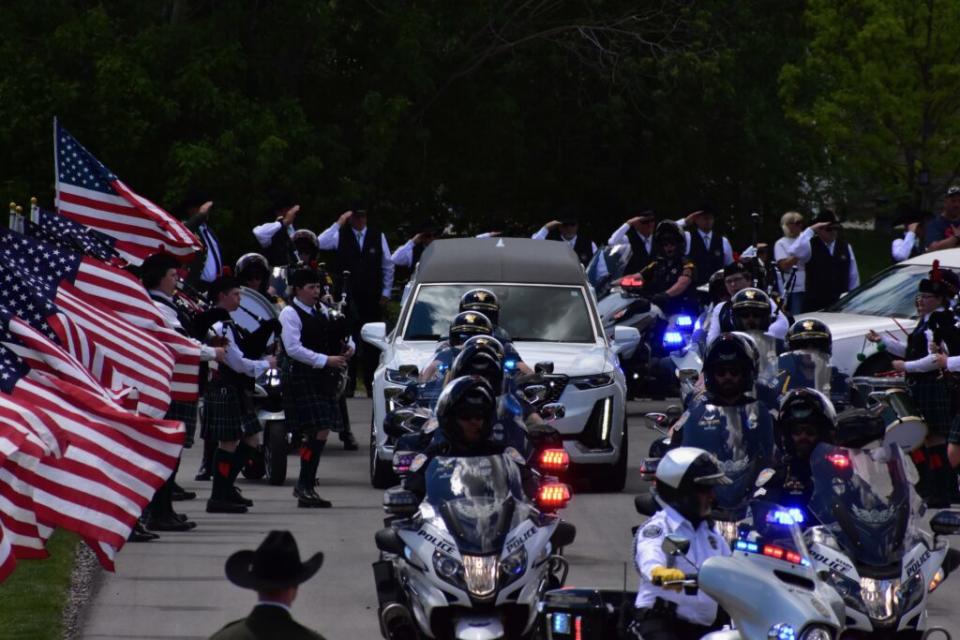  A hearse carrying Santaquin Police Sgt. Bill Hooser enters the Santaquin City Cemetary on Monday, May 13, 2024. (Kyle Dunphey/Utah News Dispatch)