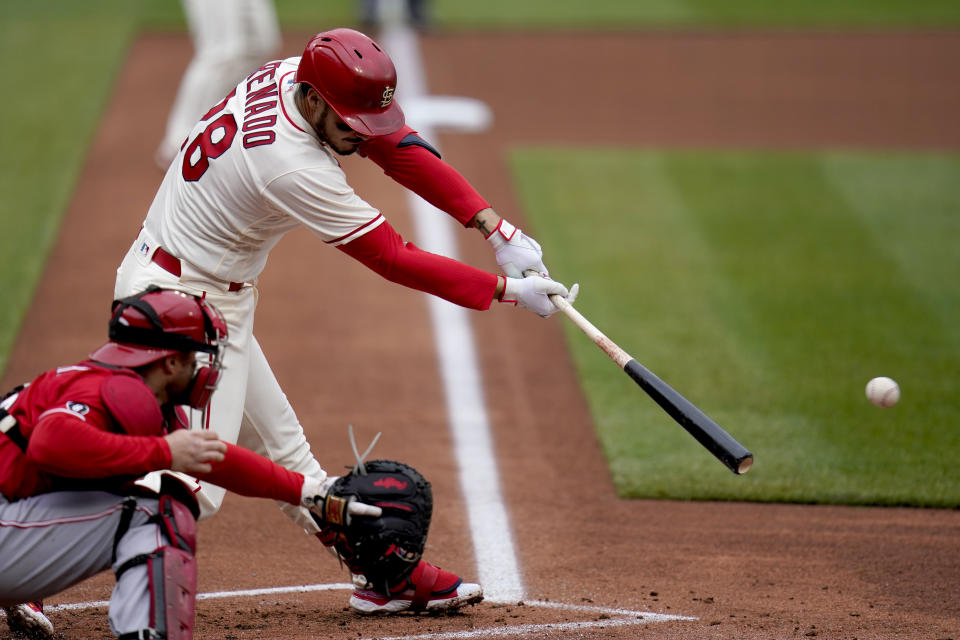 St. Louis Cardinals' Nolan Arenado hits an RBI single during the first inning of a baseball game against the Cincinnati Reds Saturday, April 24, 2021, in St. Louis. (AP Photo/Jeff Roberson)