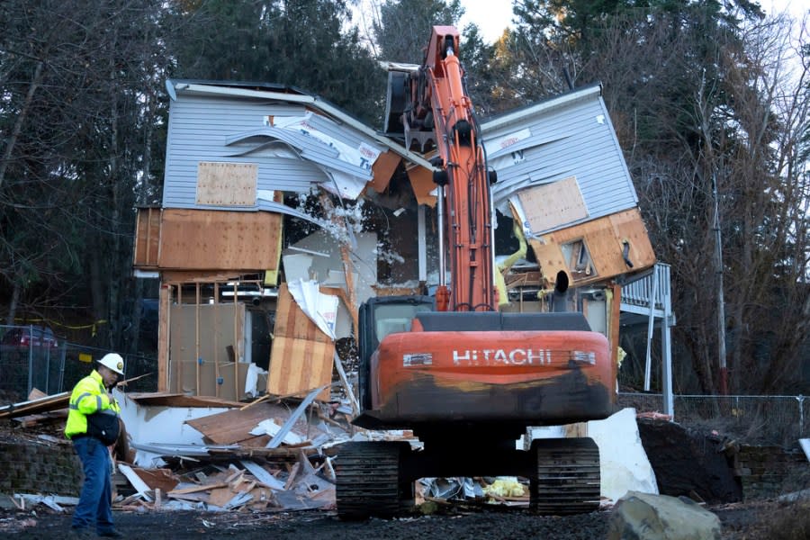 Heavy equipment is used to demolish the house where four University of Idaho students were killed in 2022 on Thursday, Dec. 28, 2023, in Moscow, Idaho. Students Ethan Chapin, Xana Kernodle, Madison Mogen and Kaylee Goncalves were fatally stabbed there in November 2022. (AP Photo/Ted S. Warren)