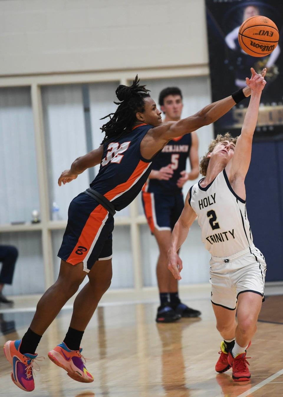 Jacob Cosby-mosley of Benjamin tries to steal the ball from Sammy Chaffiot of Holy Trinity in the state Class 3A boys basketball  tournament quarterfinals Thursday, February 16, 2023. Craig Bailey/FLORIDA TODAY via USA TODAY NETWORK