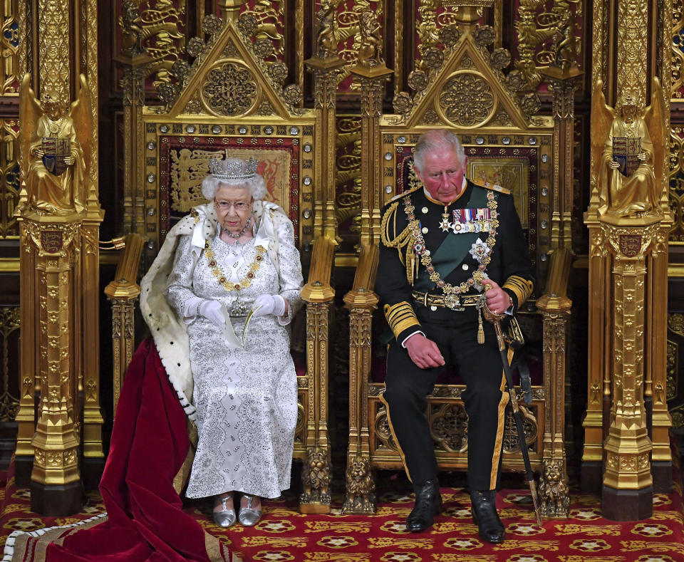 Britain's Queen Elizabeth II, with Prince Charles, delivers the Queen's Speech at the official State Opening of Parliament in London, Monday Oct. 14, 2019. (Victoria Jones/Pool via AP)