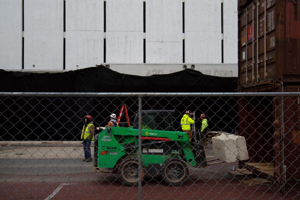 Renascent, a demolition services company, is preparing the 420 Main building, an 18-story tower, for demolition this Sunday, Nov. 21, at about 7 a.m. Concrete blocks are loaded into semi-trailers and stacked three-high to protect local business as barricades.