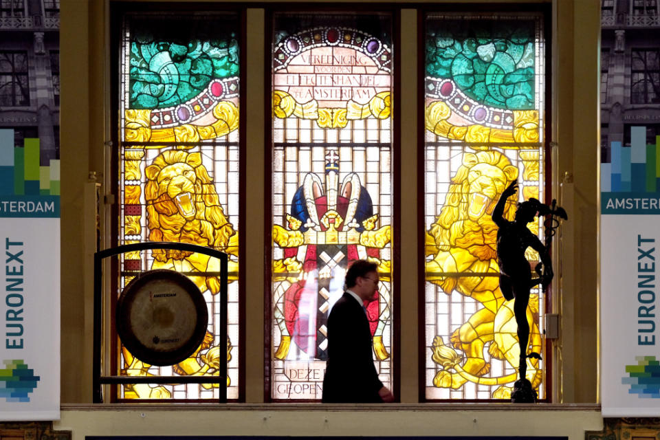 A trading gong and a statue of Mercury, the Roman god of trade, stand beside a stained glass window inside the Amsterdam Stock Exchange, operated by Euronext NV, in Amsterdam, Netherlands, on Tuesday, June 16, 2020. For two years in a row, Europes largest stock-market listings have taken place in Amsterdam, which has beguiled companies with a deep pool of international investors and corporate governance norms that tilt in favor of management teams. Photographer: Yuriko Nakao/Bloomberg via Getty Images