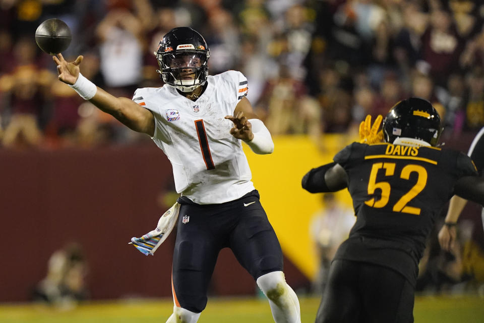 Chicago Bears quarterback Justin Fields (1) throwing ball against Chicago Bears defensive end Khalid Kareem (52) during the second half of an NFL football game, Thursday, Oct. 5, 2023, in Landover, Md. (AP Photo/Stephanie Scarbrough)
